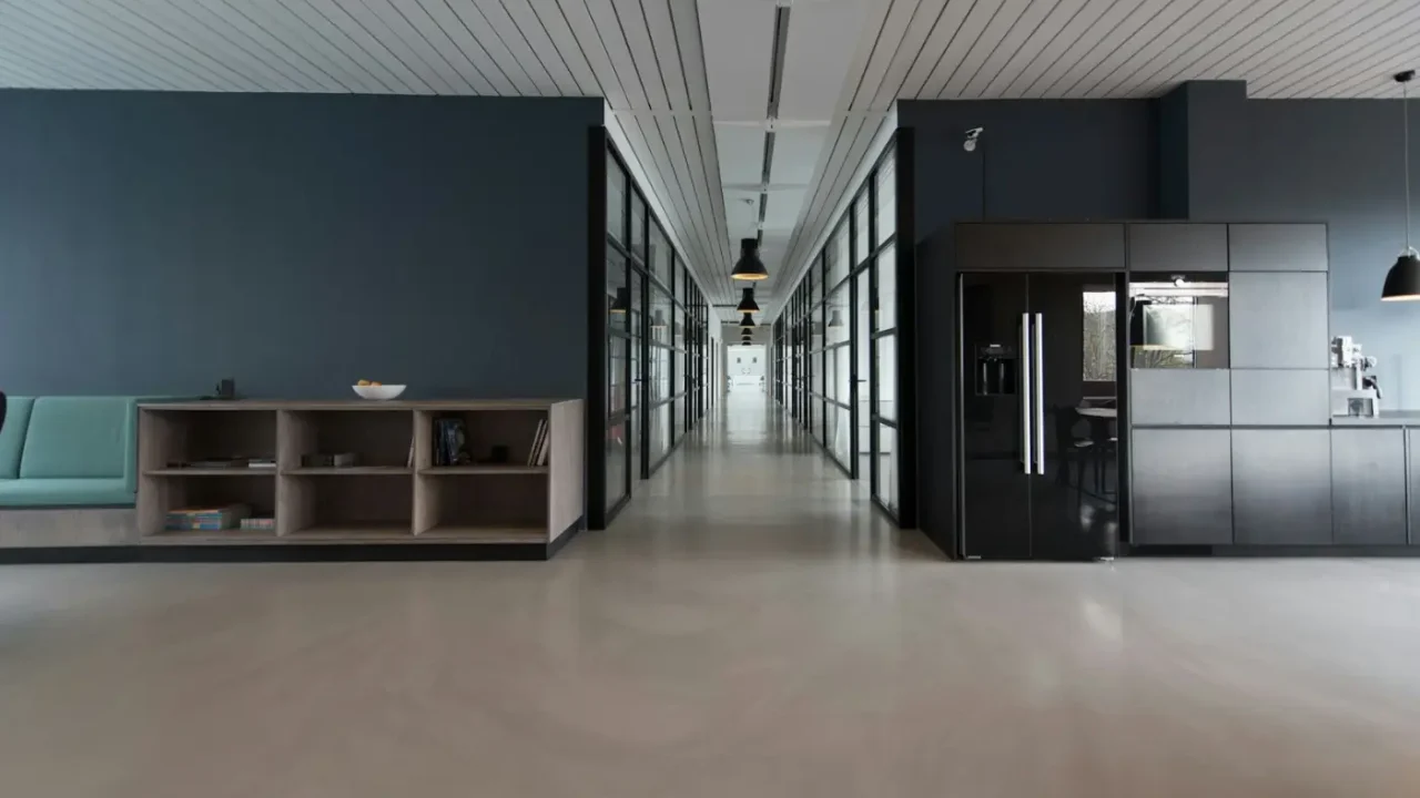 Open plan office workspace with people at computers